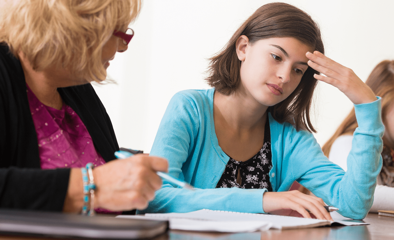 A teacher helping a seemingly frustrated student